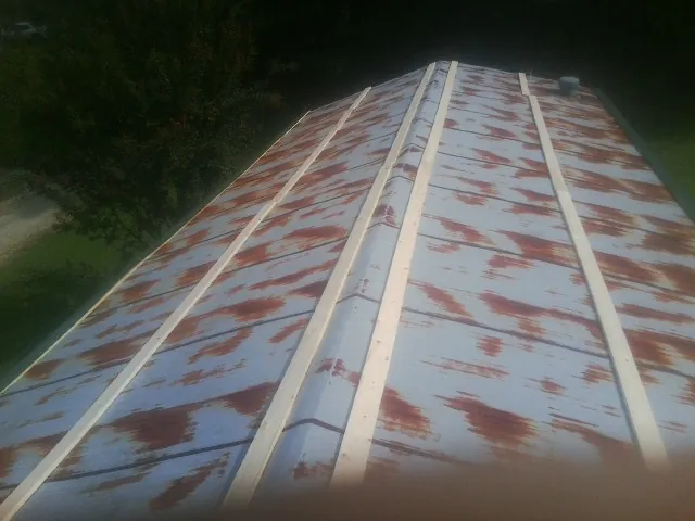 Rusted metal roof panels with new wood purlins before replacement — Storm Damage Roof Repair in Panama by Roofing Brothers