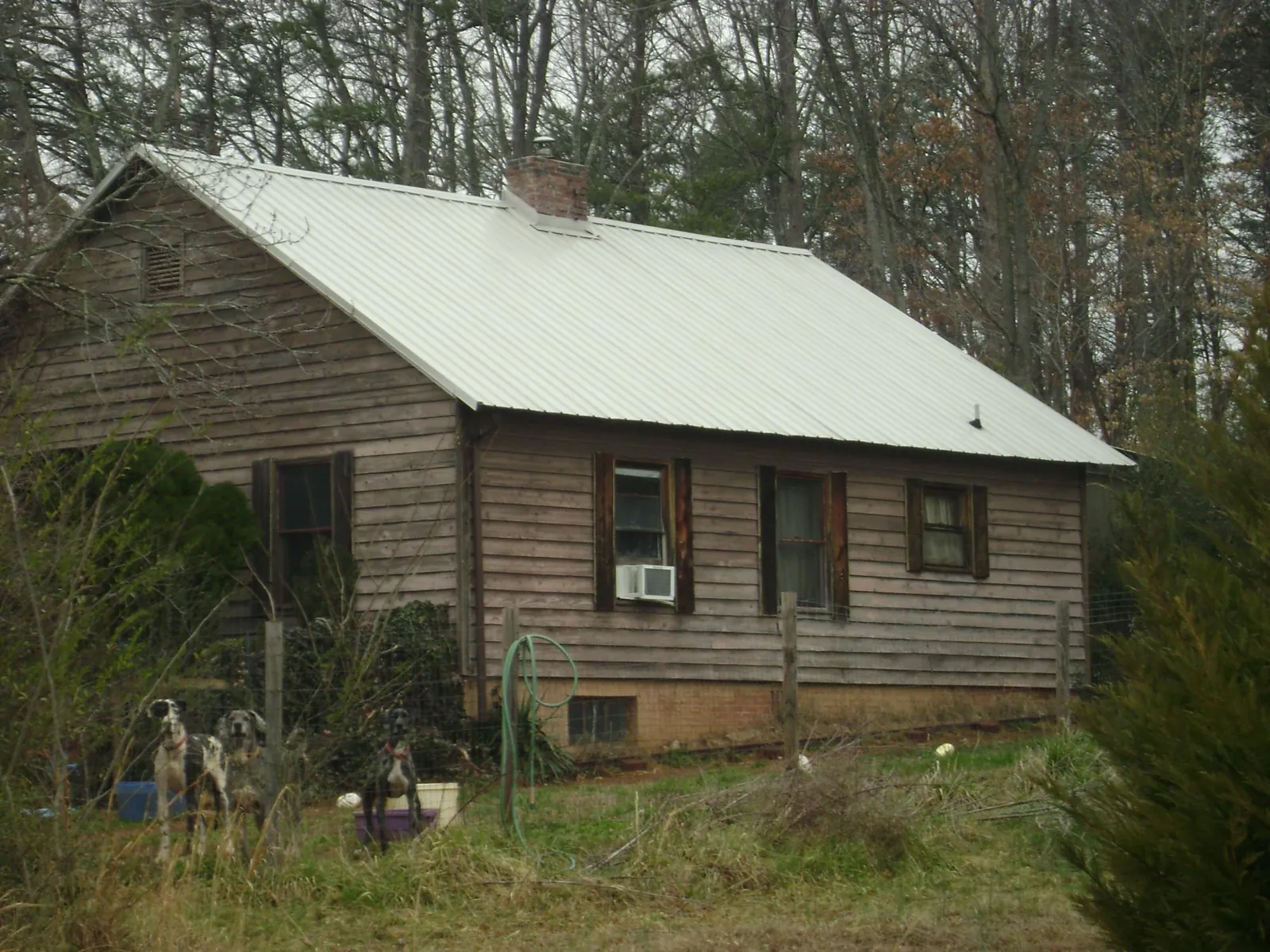 White metal roof on an old wood sided farmhouse, from a Metal Roof Installation job in Panama